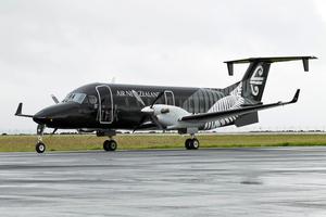 Air NZ Beech 1900 black - on ground.
